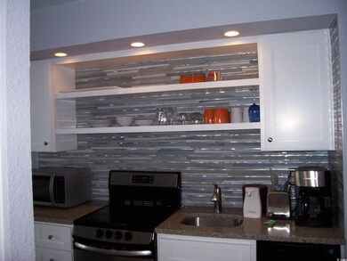 Kitchen featuring backsplash, white cabinets, and 