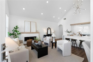 Living room with high vaulted ceiling, sink, hard 