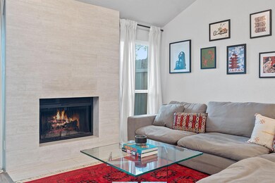 Living room with a fireplace and vaulted ceiling