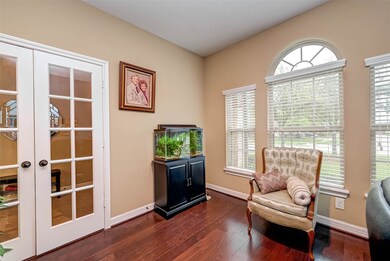 Right off the entryway is a private office with glass French doors.