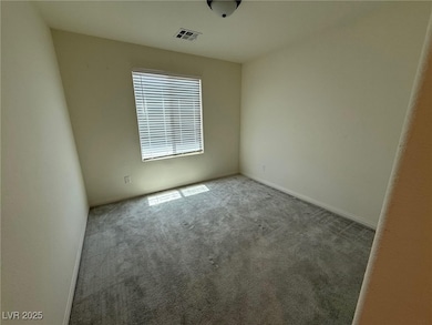 Carpeted empty room with baseboards