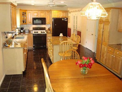 Kitchen. Large granite island and sliders to the 3
