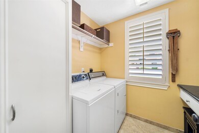 Spacious laundry room near kitchen.