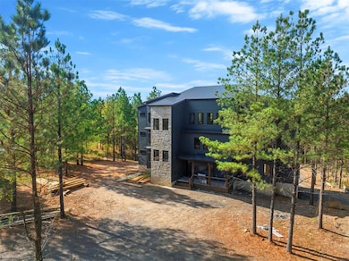 View of front facade with stone siding and a metal roof