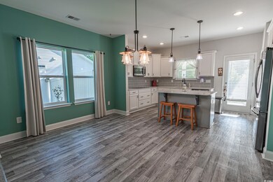 Kitchen featuring stainless steel appliances, whit