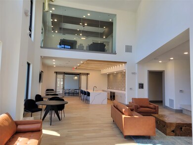 Living room featuring a barn door and light wood-t