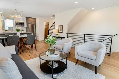 The nice, open living room gets great natural light and has it all, 1/2 bath and balcony on this floor as well. 