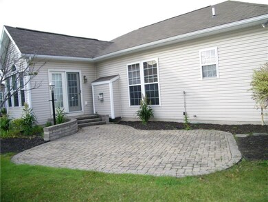 Stone patio with steps leading to the heated sunro