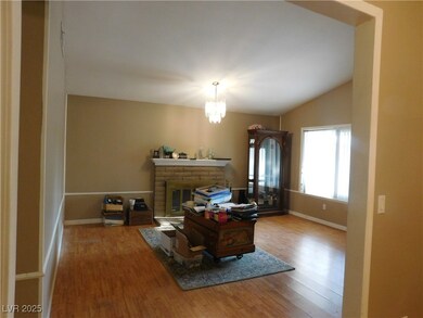 Home office featuring wood finished floors, a fire