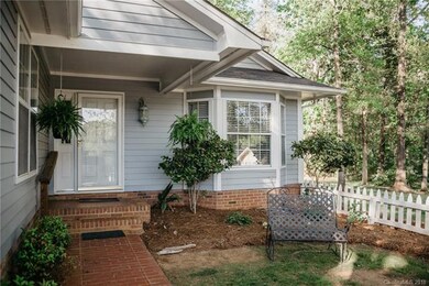 Paved path and white picket fenced framed garden a