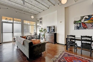 Living area featuring a towering ceiling, finishe