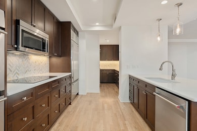 Large kitchen with lots of counter space and cabinet storage.