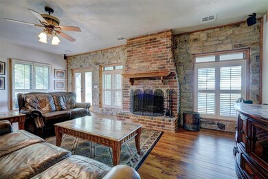 Living room featuring ceiling fan, plenty of natur
