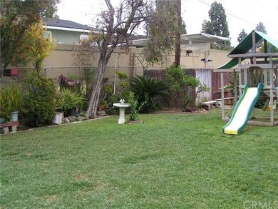 Back yard is landscaped and has a large lawn for p
