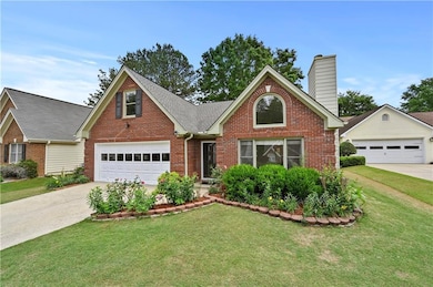 Traditional-style home with brick siding, a garage