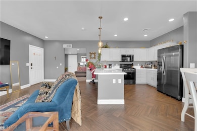 Kitchen with stainless steel appliances, open floo