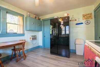 Kitchen with black refrigerator with ice dispenser