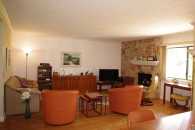 LIVING ROOM WITH STONE FIREPLACE WALL, LAMINATE FL