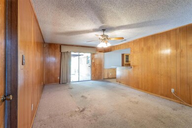 Carpeted empty room with a textured ceiling, ceili