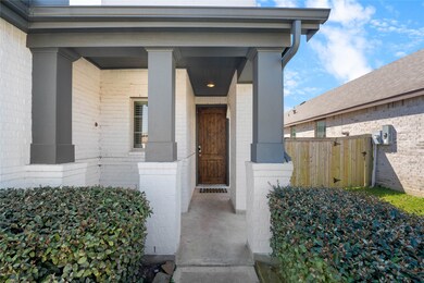 Covered front porch with stately columns and upgraded front door—perfect for relaxing with a morning coffee.