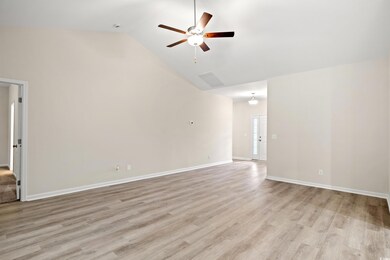 Unfurnished room with ceiling fan, high vaulted ce