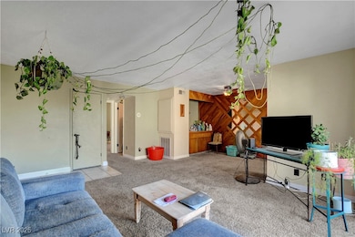 Living room with wooden walls and carpet flooring