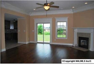 Beautiful family room with extensive trim, gas-log fireplace and hardwood flooring.