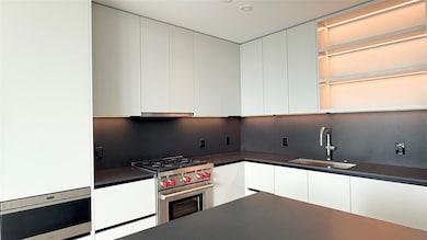 Kitchen with white cabinets, modern cabinets, sta