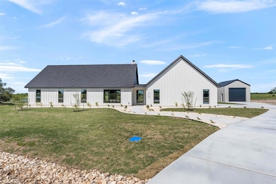 Modern inspired farmhouse featuring a front lawn,