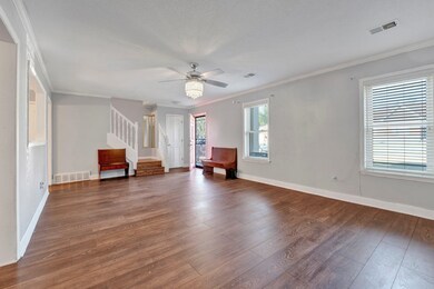Unfurnished room featuring ceiling fan, crown mold