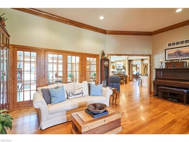 The living room is bright and cheery with wood floors and glass french doors  backs up to the sun room!
