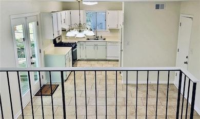 Kitchen featuring visible vents, plenty of natural