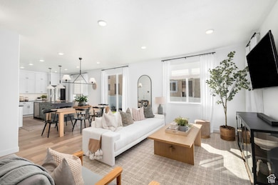 Open and inviting living and dining space just off the kitchen, filled with natural light—perfect for entertaining or enjoying gatherings with friends and loved ones.*Model