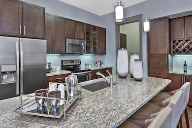 Kitchen with stainless steel appliances, light sto