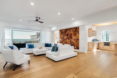 Living area featuring light wood-style floors, ceiling fan, and recessed lighting