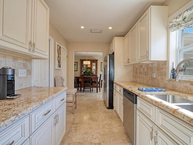 Beautiful solid wood cabinets with granite tops, newer windows, appliances and a walk in pantry too!  The side door goes to the garage!