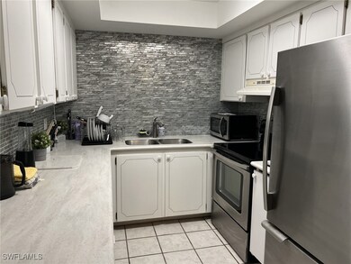 Kitchen with decorative backsplash, appliances wit