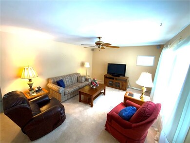 Large living room with hardwood floors under carpe