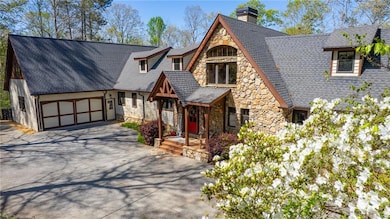 View of front facade featuring a chimney, driveway