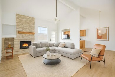 Living area featuring high vaulted ceiling, beam 