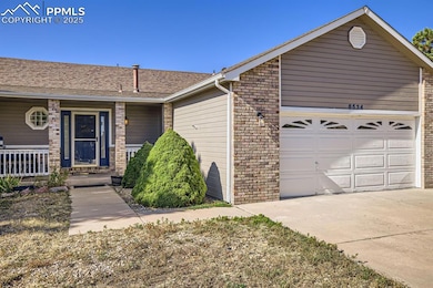 Ranch-style house featuring a shingled roof, an at