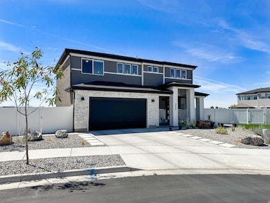 View of front of property with stone siding, a gate, solar panels, concrete driveway, and a garage