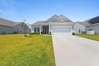 View of front of house featuring concrete driveway, an attached garage, a front yard, and a shingled roof