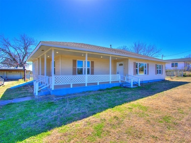View of front of property with a front yard, cover