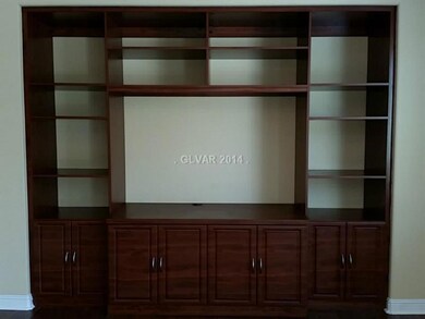 Property Photo. Custom dark wood built in media ce