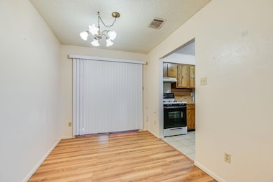 Unfurnished dining area with visible vents, a tex