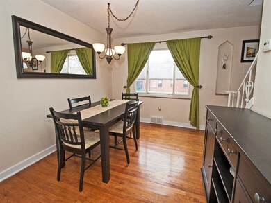 The dining room also has hardwood floors and neutr
