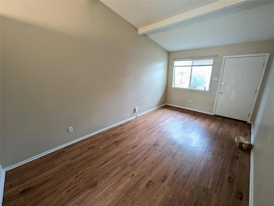 Empty room featuring dark wood-type flooring and 