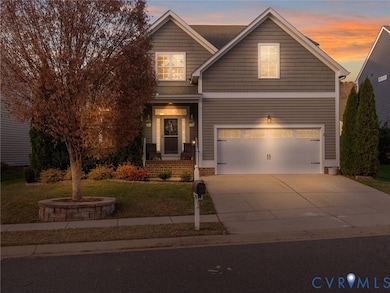 View of front of home with a front lawn, a porch, concrete driveway, and a garage