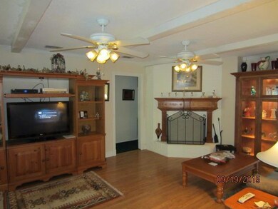 Den with custom fireplace mantel and built in curi